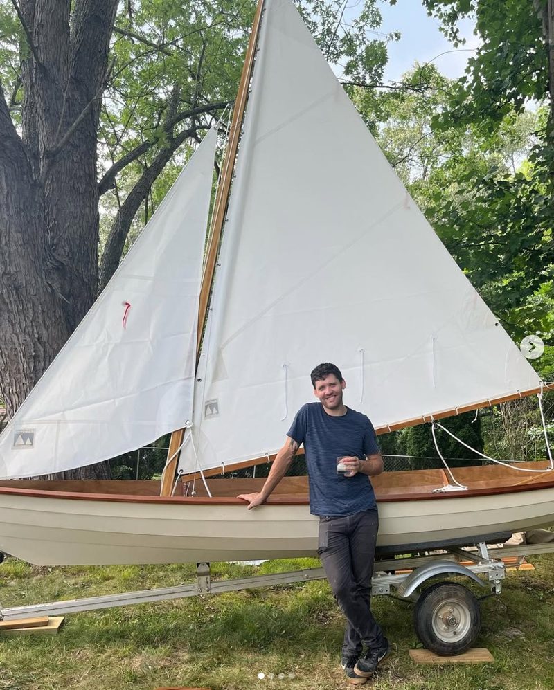 Riley West with a handbuilt sailboat