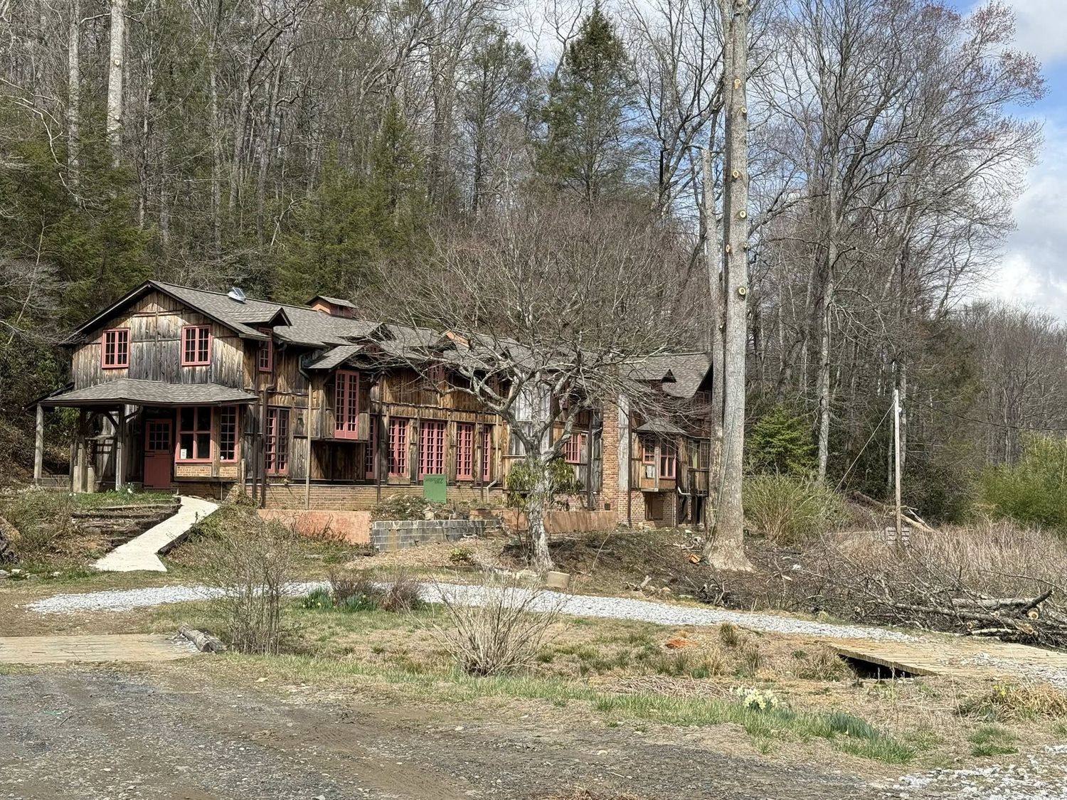The Celo Inn standing among bare trees in early spring after Hurricane Helene