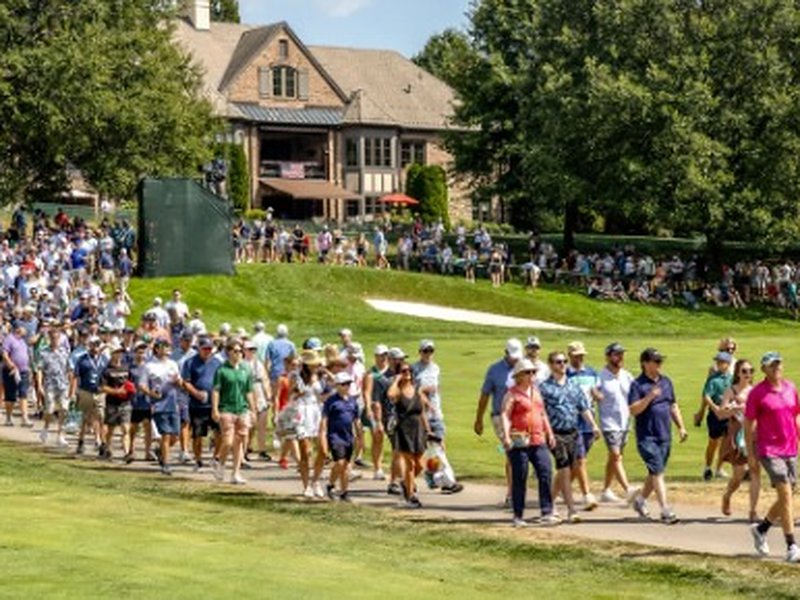 Crowds of fans walking a fairway at the Biltmore Championship Asheville