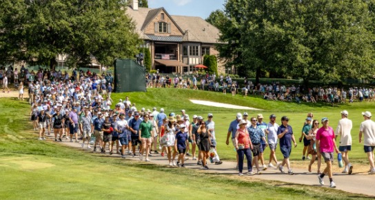 Crowds of fans walking along a fairway at the inaugural Biltmore Championship Asheville