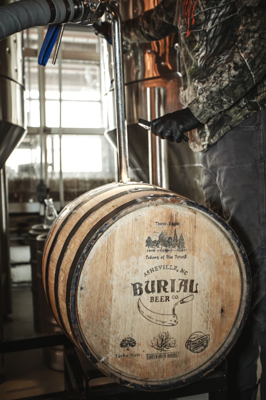 An oak barrel made from Hurricane Helene–salvaged timber and branded with the Echoes of the Forest and Burial Beer Co. marks
