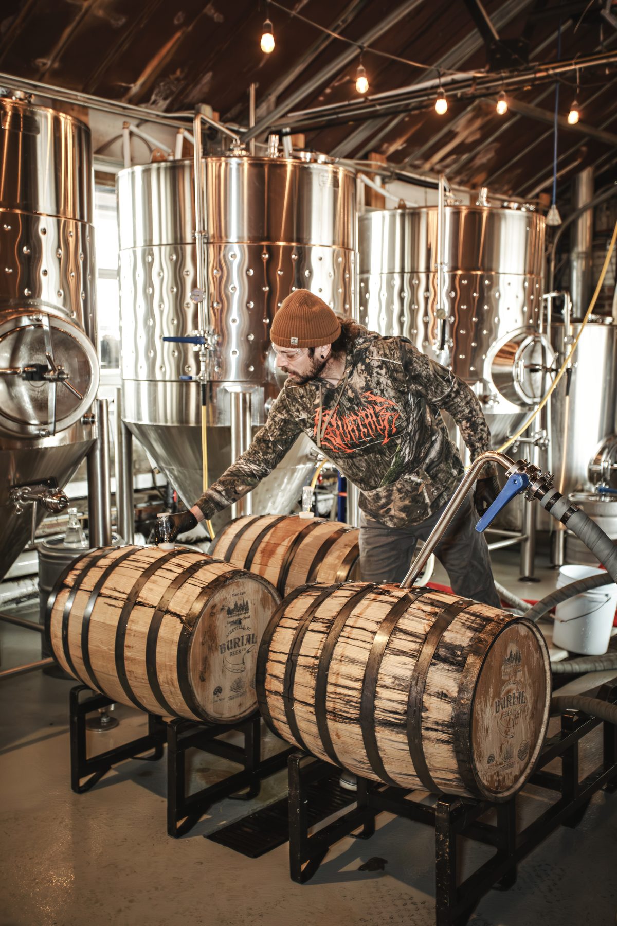 Tim Gormley, head brewer at Burial Beer Co., sealing freshly filled Echoes of the Forest oak barrels at the Forestry Camp brewery in Asheville