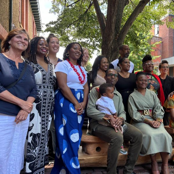 Community members and project partners pose together at the unveiling