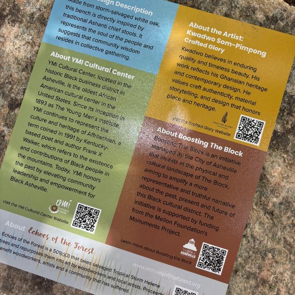 The interpretive sign installed beside the bench, describing the design, the artist, the YMI Cultural Center, and the Boosting The Block initiative