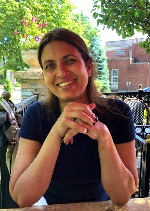 Volunteer Anita Mann smiling at an outdoor café