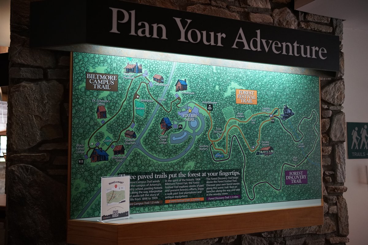 The Plan Your Adventure trail map inside the Cradle of Forestry visitor center, showing the Biltmore Campus Trail, Forest Festival Trail, and Forest Discovery Trail