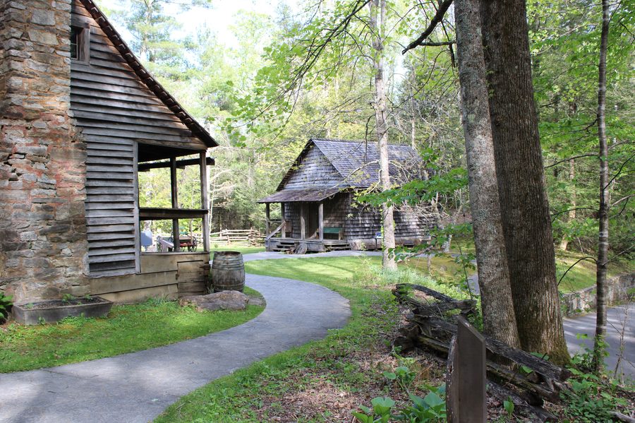 Historic timber and shake-shingle buildings along the path through the Cradle of Forestry's preserved early-20th-century forestry school grounds