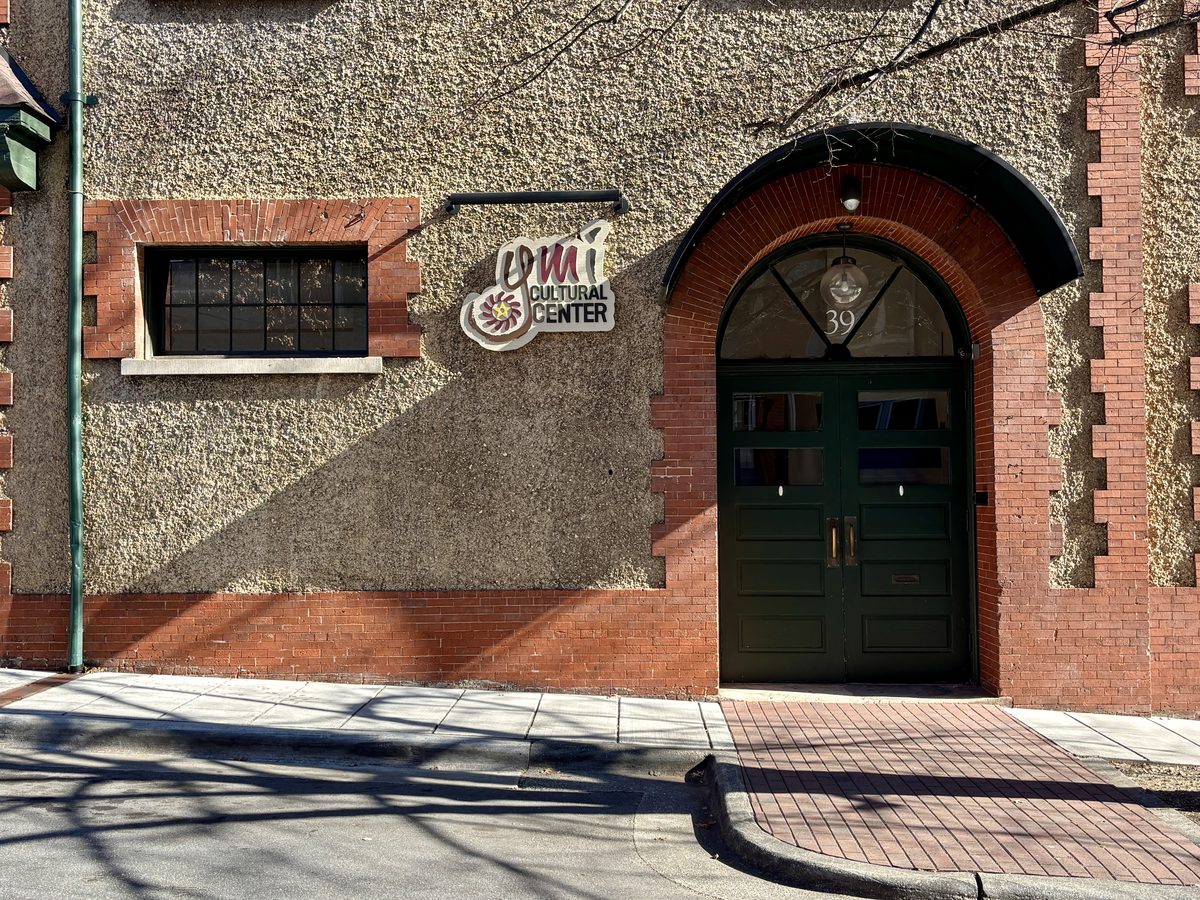 Close-up of the YMI Cultural Center entrance and signage on its historic brick facade
